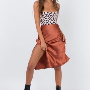 Princess Polly Midi Satin Skirt in rust burnt orange